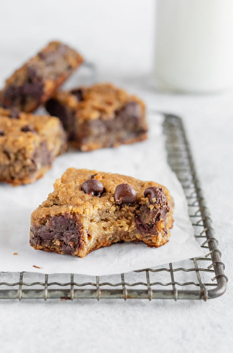 Chickpea blondies with chocolate chips cut into squares on a baking tray
